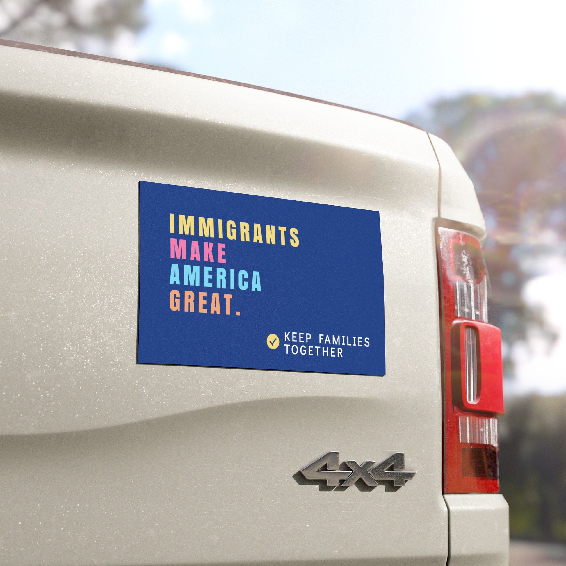 Vehicle with a political magnet on the back, featuring text "Immigrants Make America Great, Keep families together". Anti-MAGA car magnet.