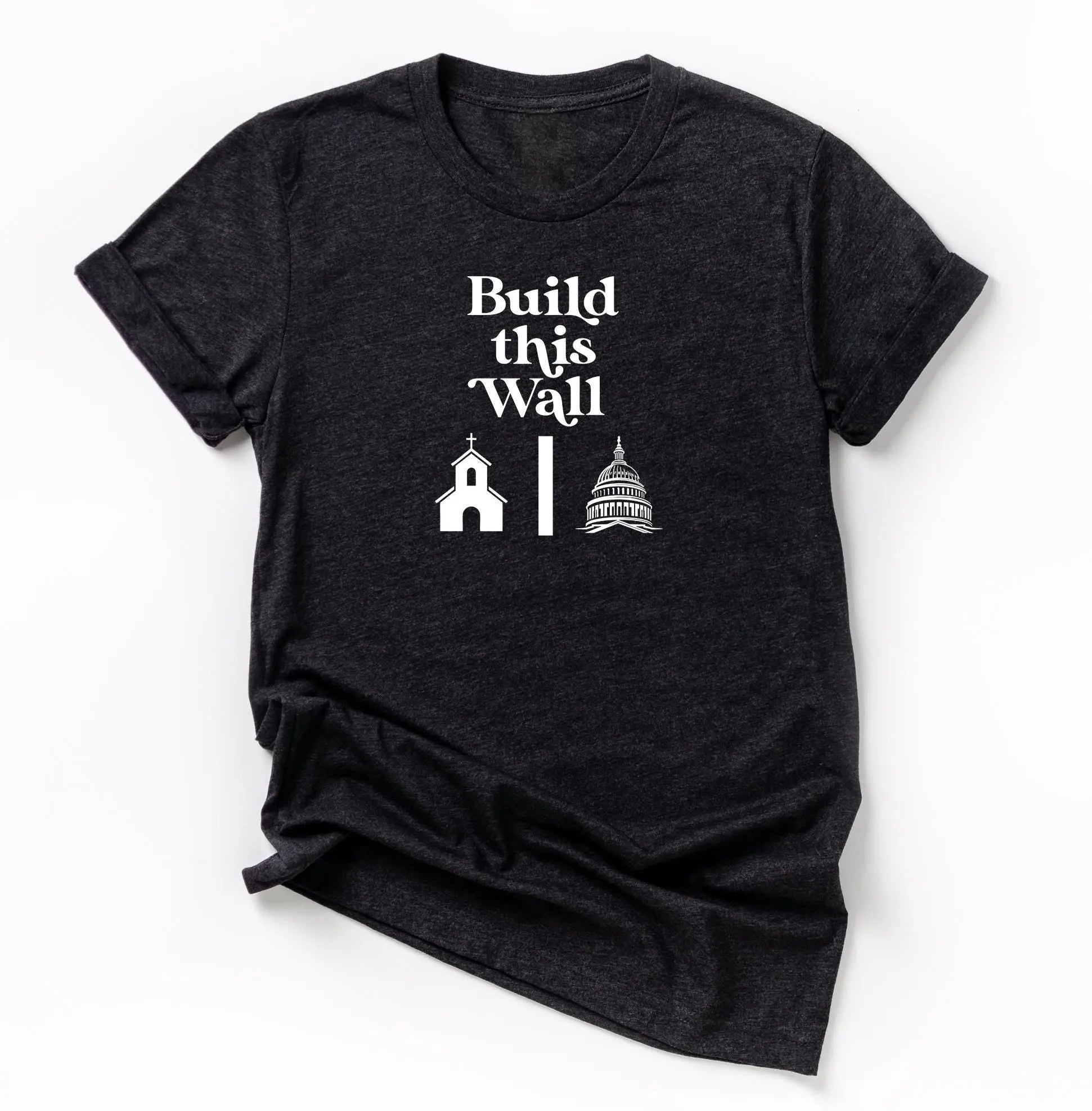 build this wall shirt.  black short sleeve shirt with white modern retro font and graphics of church being separated by wall and capital government building on other side.  snarky atheist shirt making fun of trump&#39;s wall plan.  anti-trump shirt.