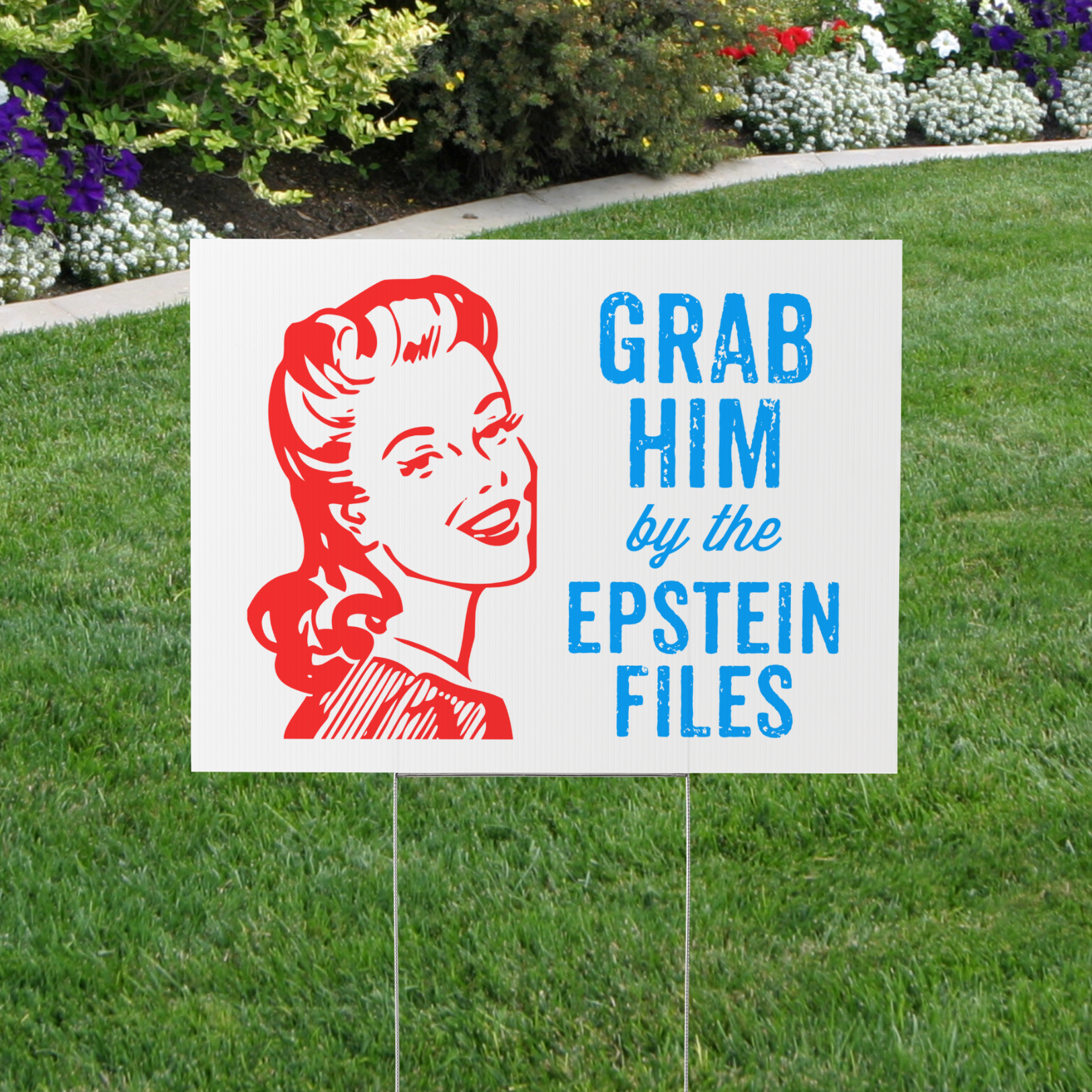 Garden sign with a graphic of a woman's face and text 'Grab Him by the Epstein Files' on a grassy lawn.
