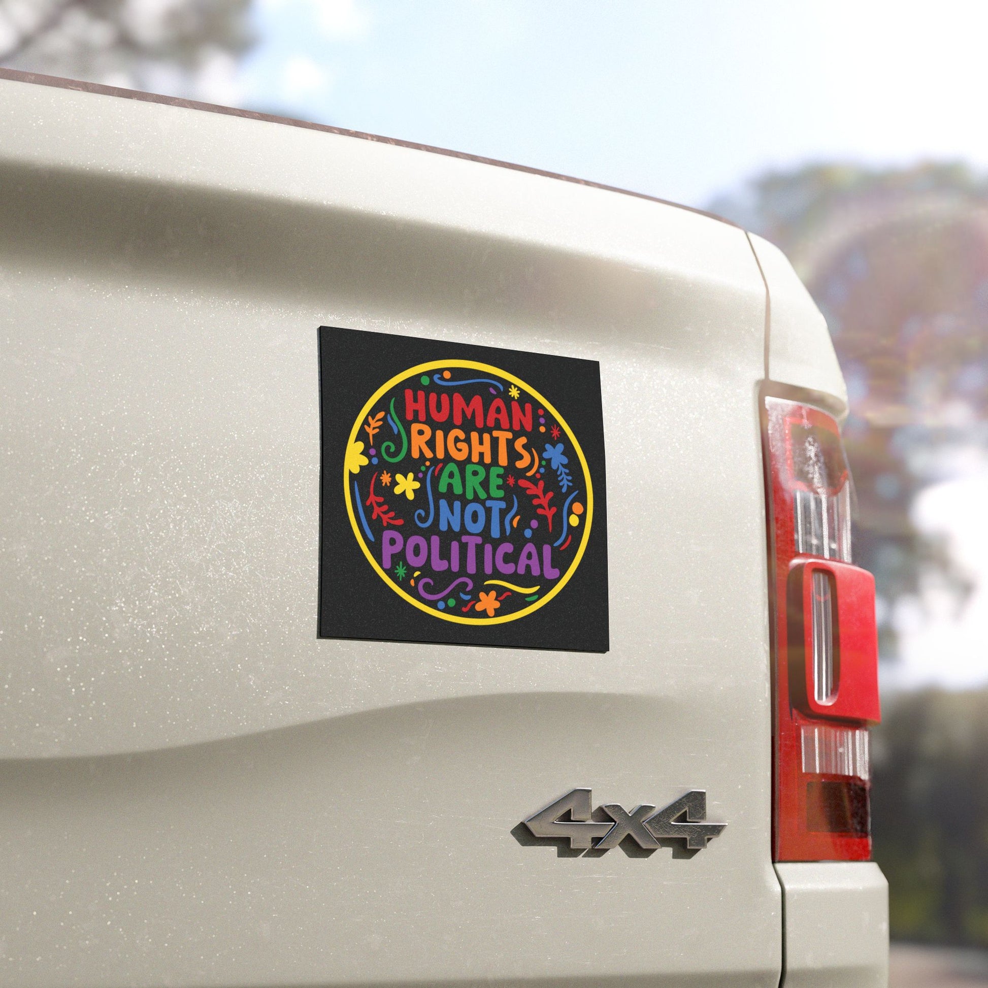 Bumper Car Magnet on a truck reading 'Human rights are not political' in rainbow folk design