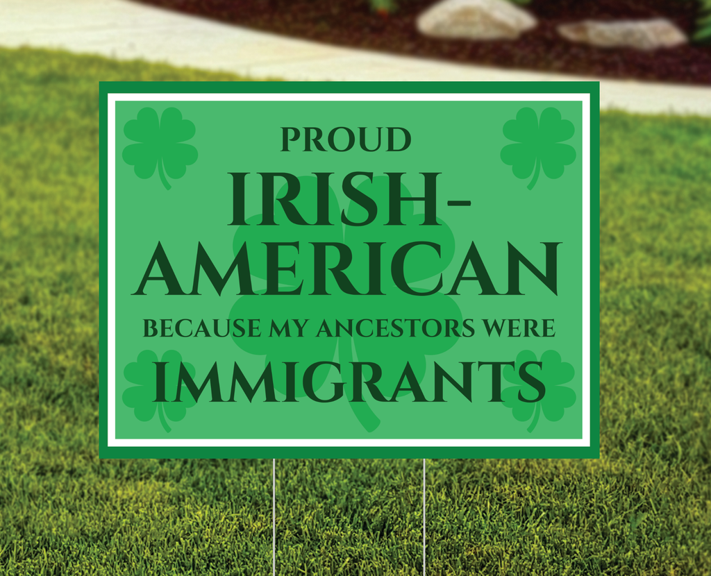 Green sign with text 'Proud Irish-American because my ancestors were immigrants' on grass