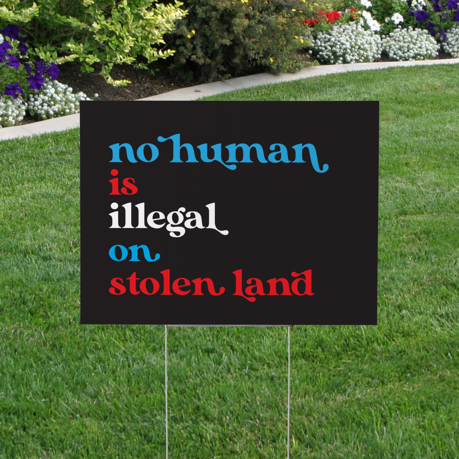 No Human is Illegal on Stolen Land Yard Sign
