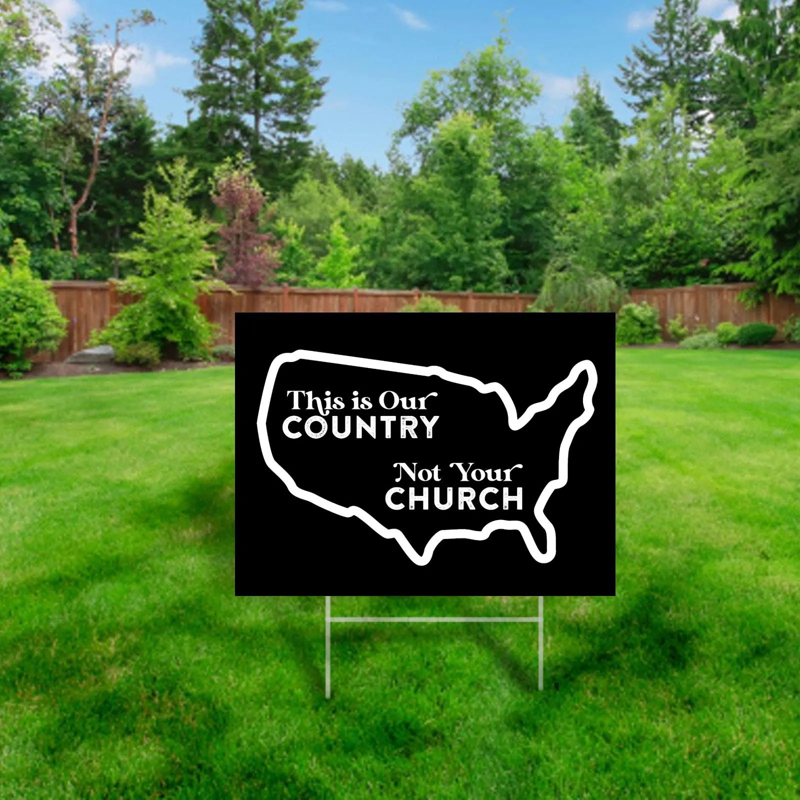 Black and White yard sign with outline of united states.  Inside reads "this is our country, not your church"