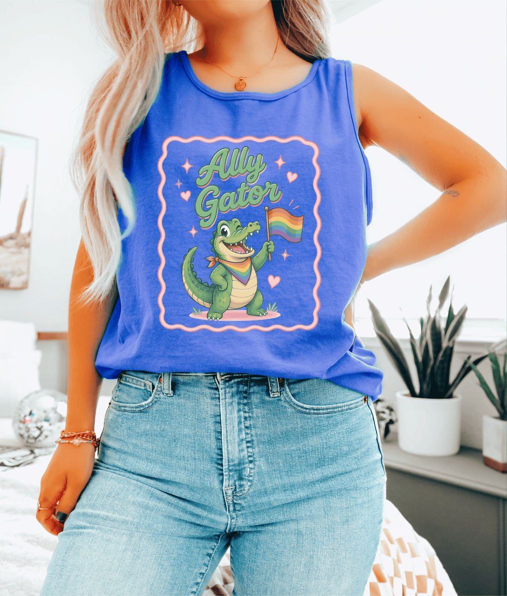 Person wearing a blue tank top with a graphic of a crocodile holding a rainbow flag and the text 'Ally Gator'.
