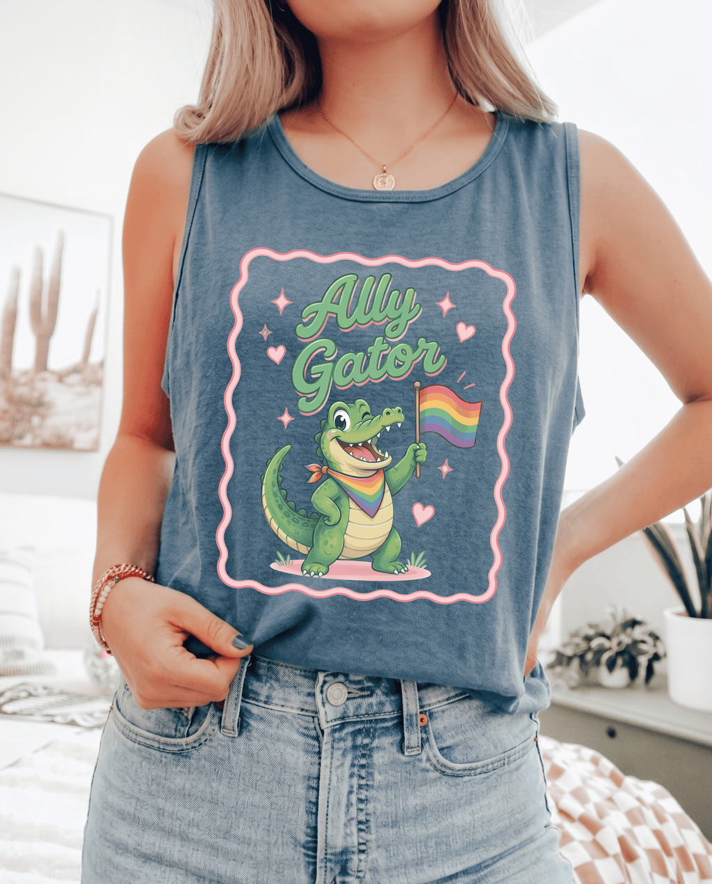 Person wearing a tank top with a cartoon gator holding a rainbow flag and 'Ally Gator' text.
