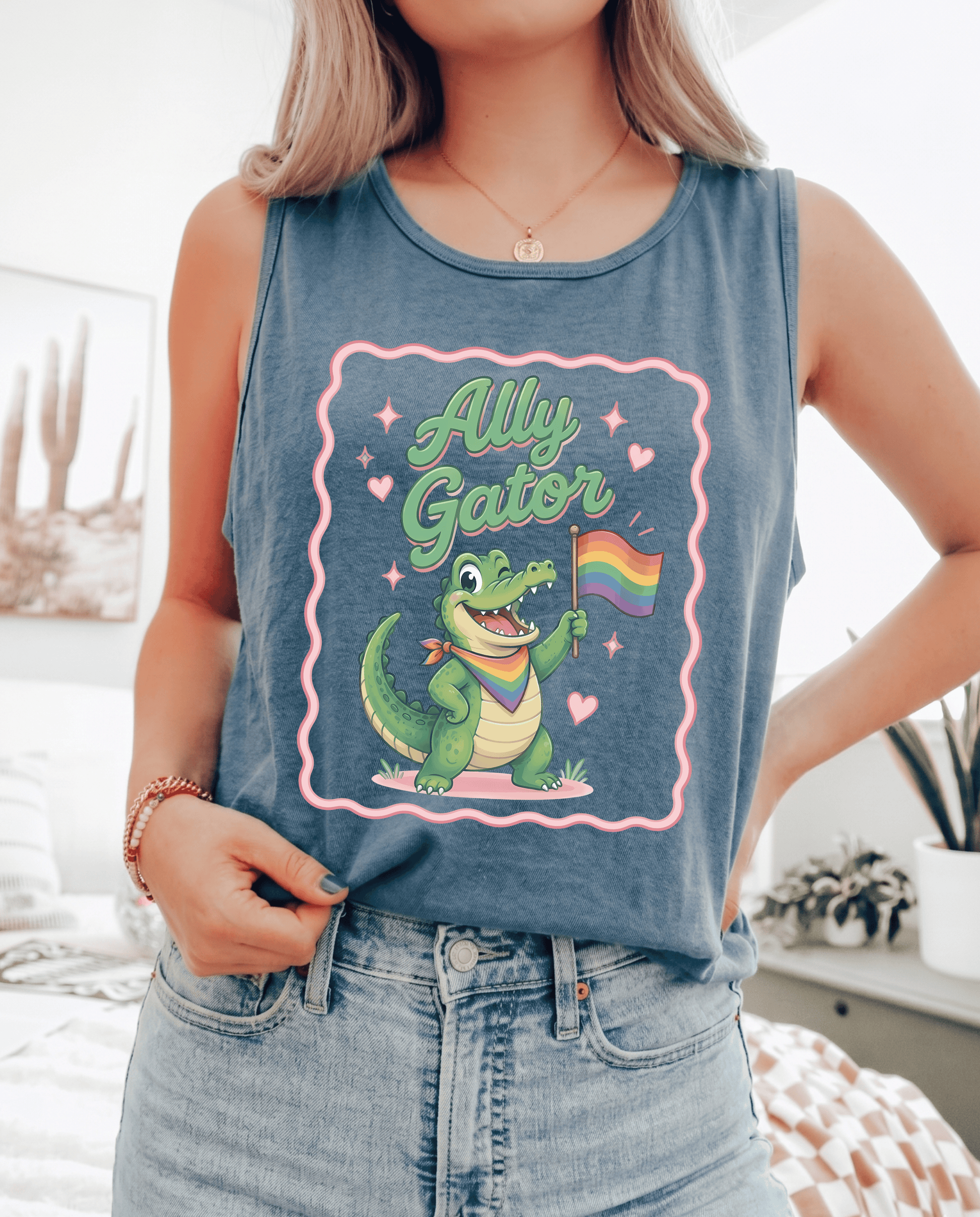 Person wearing a tank top with a cartoon gator holding a rainbow flag and 'Ally Gator' text.