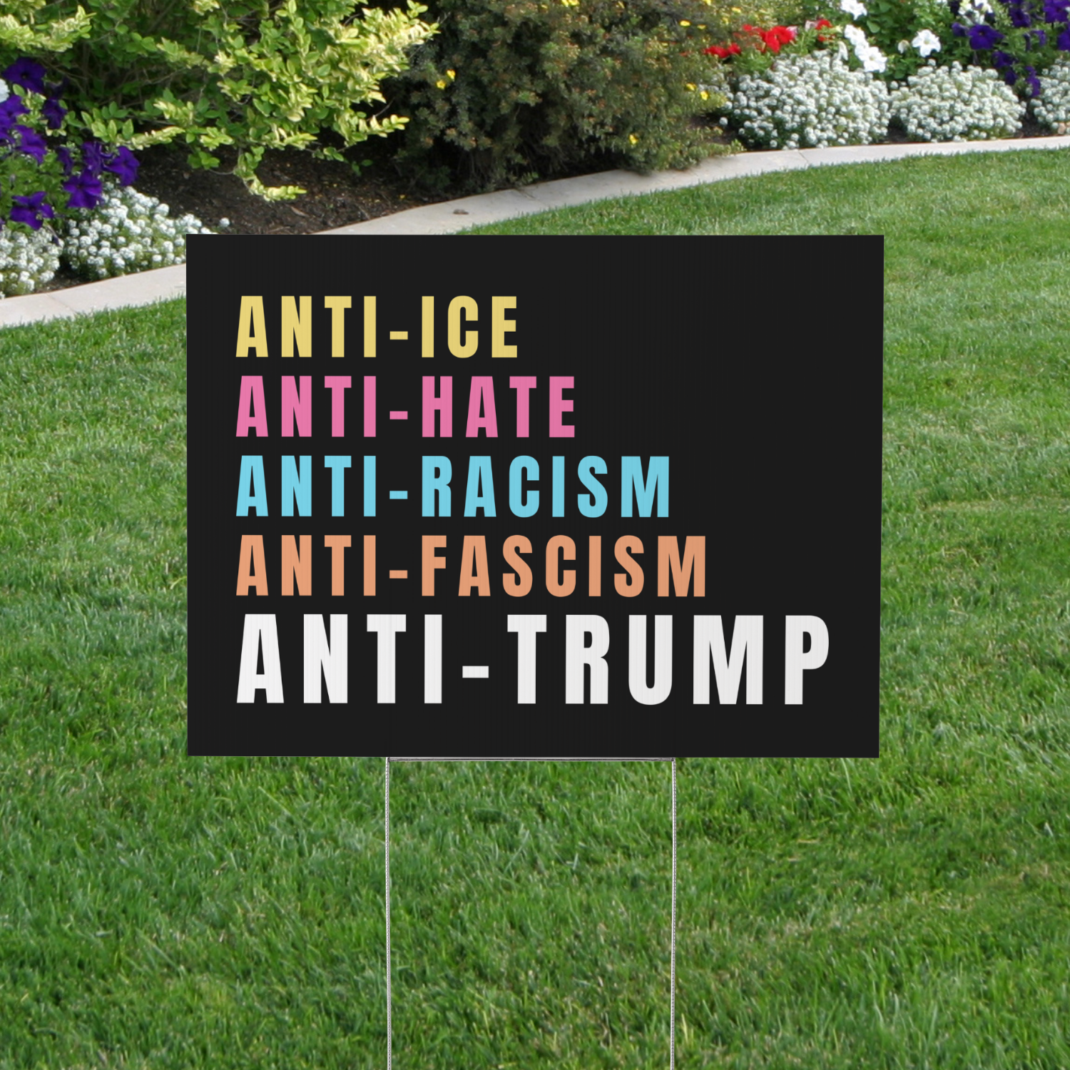 black yard sign with pastel wording reads "Anti-ICE Anti-Hate Anti-Racism Anti-Fascism Anti-Trump"