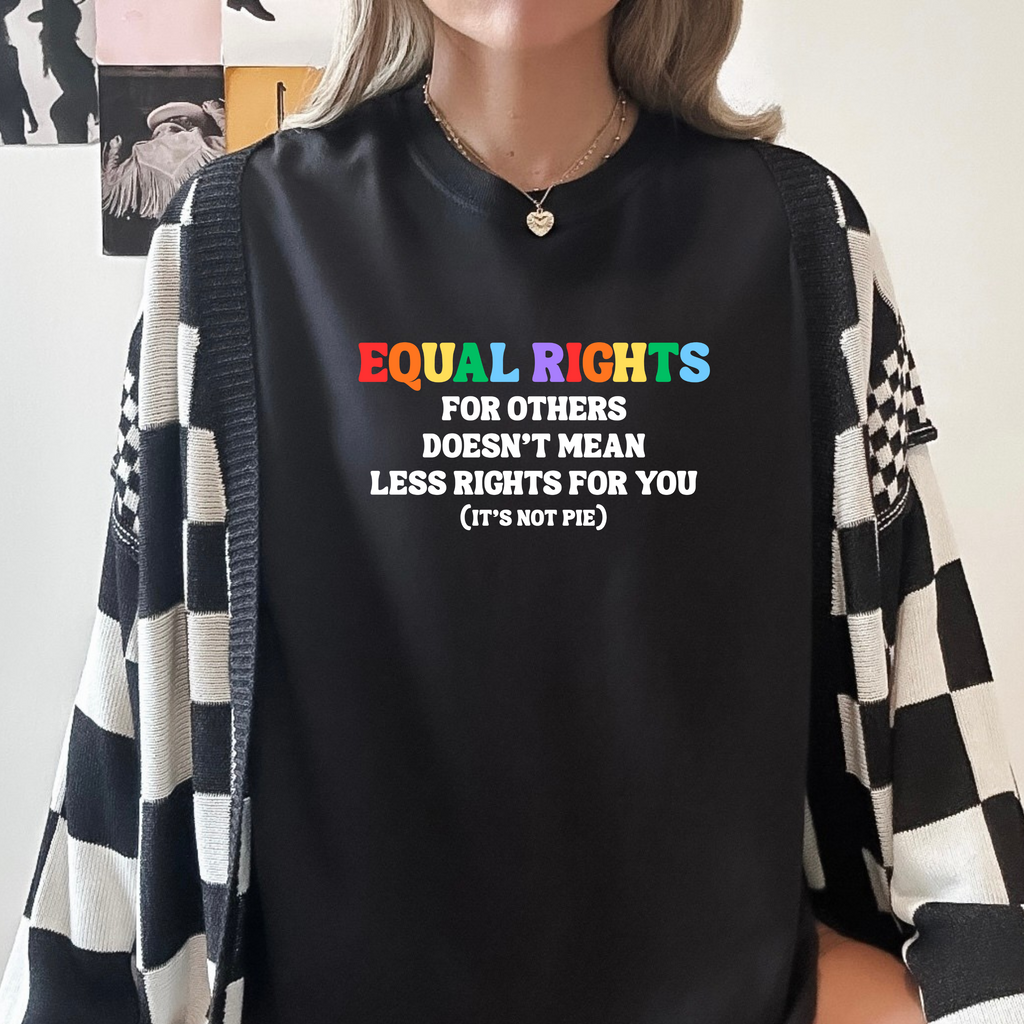 A person wearing a black long-sleeve bodysuit with the text 'EQUAL RIGHTS FOR OTHERS DOESN'T MEAN LESS RIGHTS FOR YOU (IT'S NOT PIE)' printed on the front, styled with a black and white checkered cardigan.