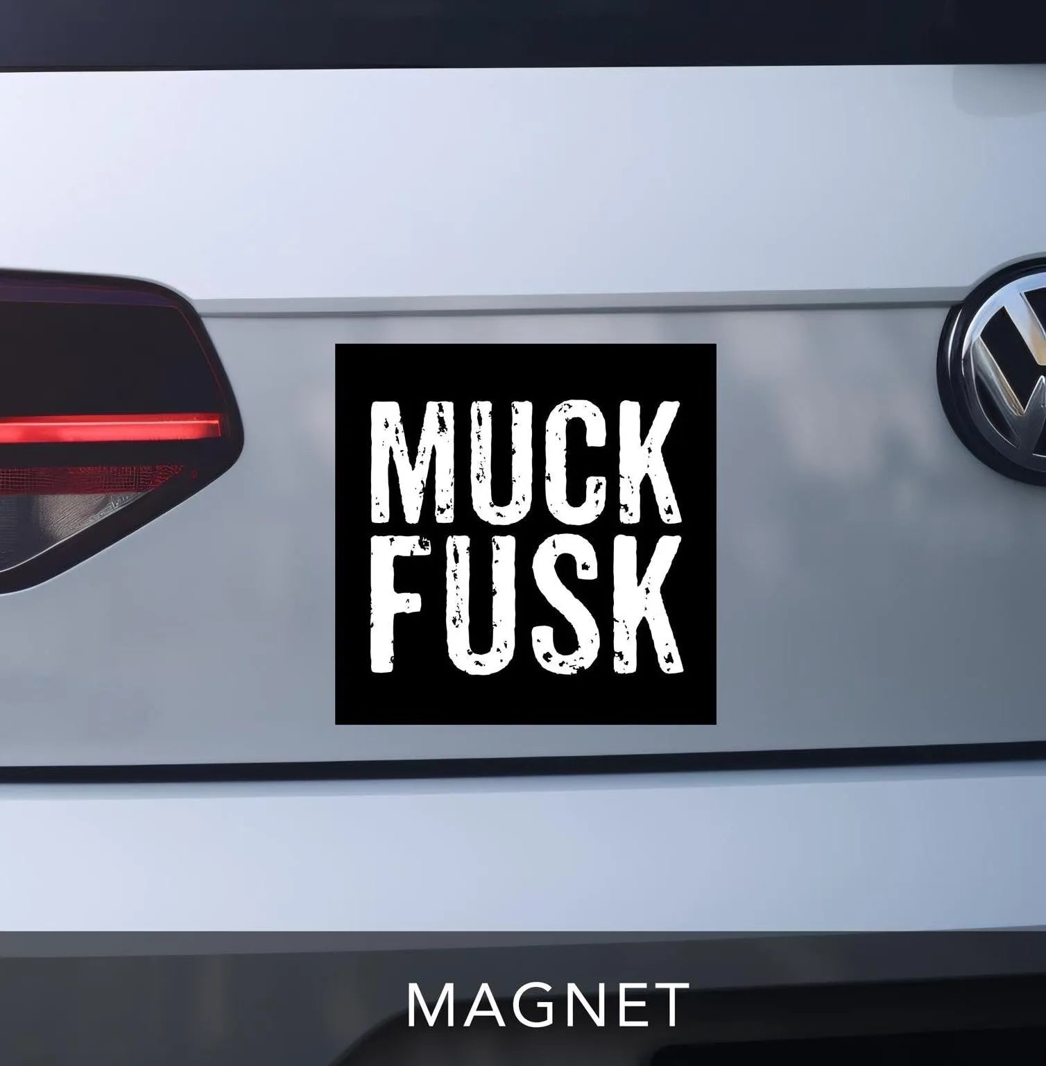 muck fusk car magnet.  anti-elon bumper sticker magnet.  black square magnet with white distressed block lettering.