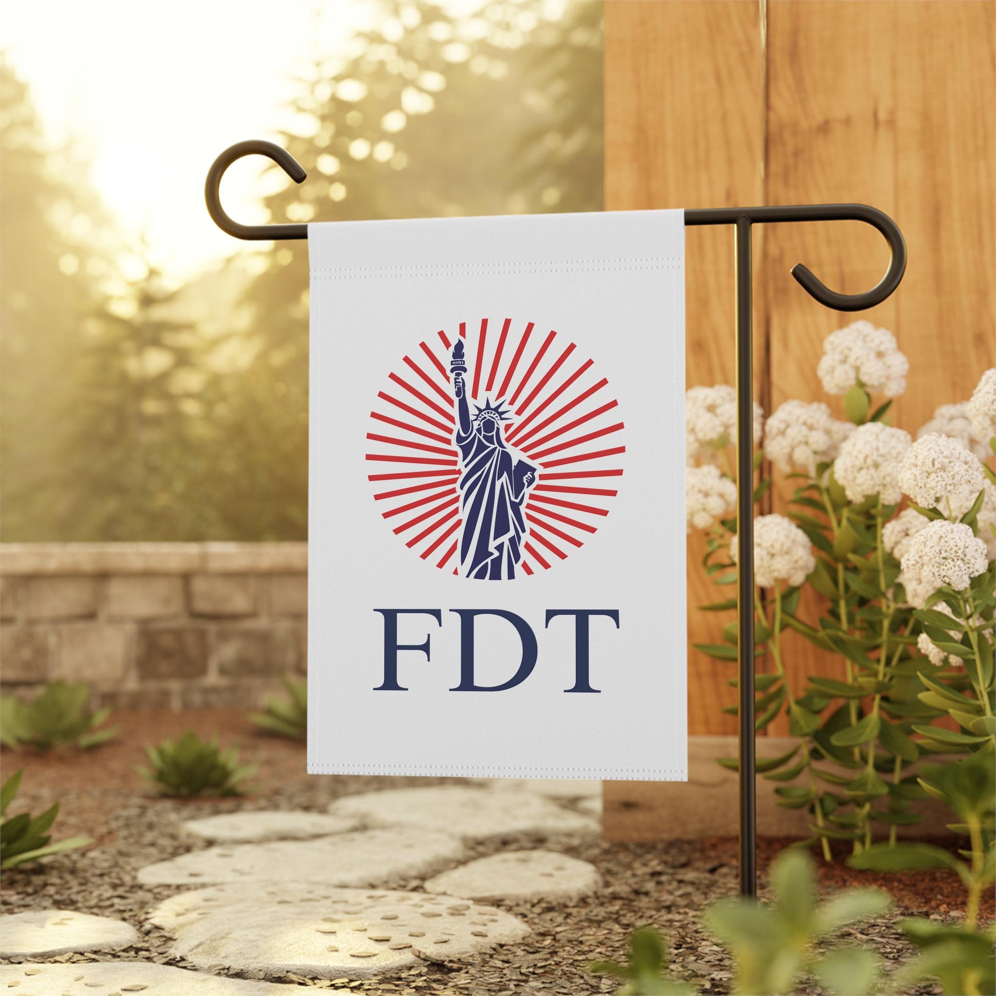 FDT garden flag design with Statue of Liberty, red sunburst background, and bold navy text